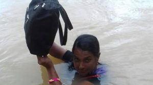 Binodini Samal - teacher wades in neck-deep water to reach school
